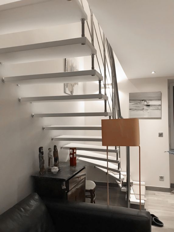 Escalier suspendu en bois blanc et garde-corps en acier inoxydable | Treppenmeister